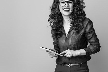 smiling modern woman against background using tablet PC, a Person Photo by Alliance Images
