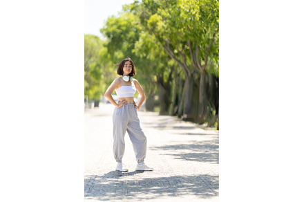 A woman is standing on a sidewalk