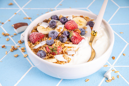 Breakfast yogurt granola bowl with fruit and berry, a Food & Drink Photo by Rimma
