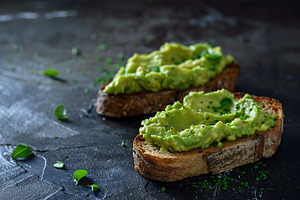 Toast breads with avocado puree on grey background. Vegetarian food., a Food & Drink Photo by AlyaAnd