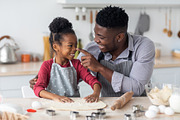 Loving african american family haivng fun while baking at home, a Photo by Prostock-Studio (Thumbnail 2 of 2)