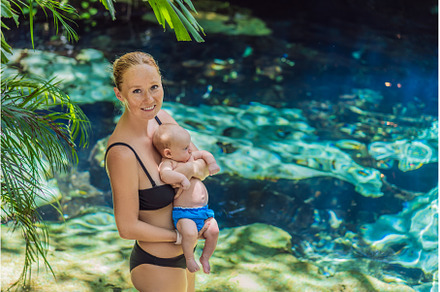 Mother with her baby standing by a
