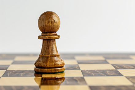 Chess pawn on chessboard on white background, a Sports & Recreation Photo by AlyaAnd