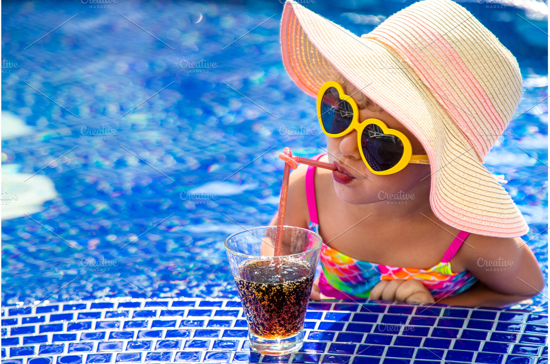 A child near the pool in sunglasses, a Person Photo by yanadjana