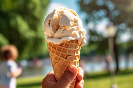 Children hand holding ice cream in waffle, outdoors. Generative AI, a Food & Drink Photo by AlyaAnd
