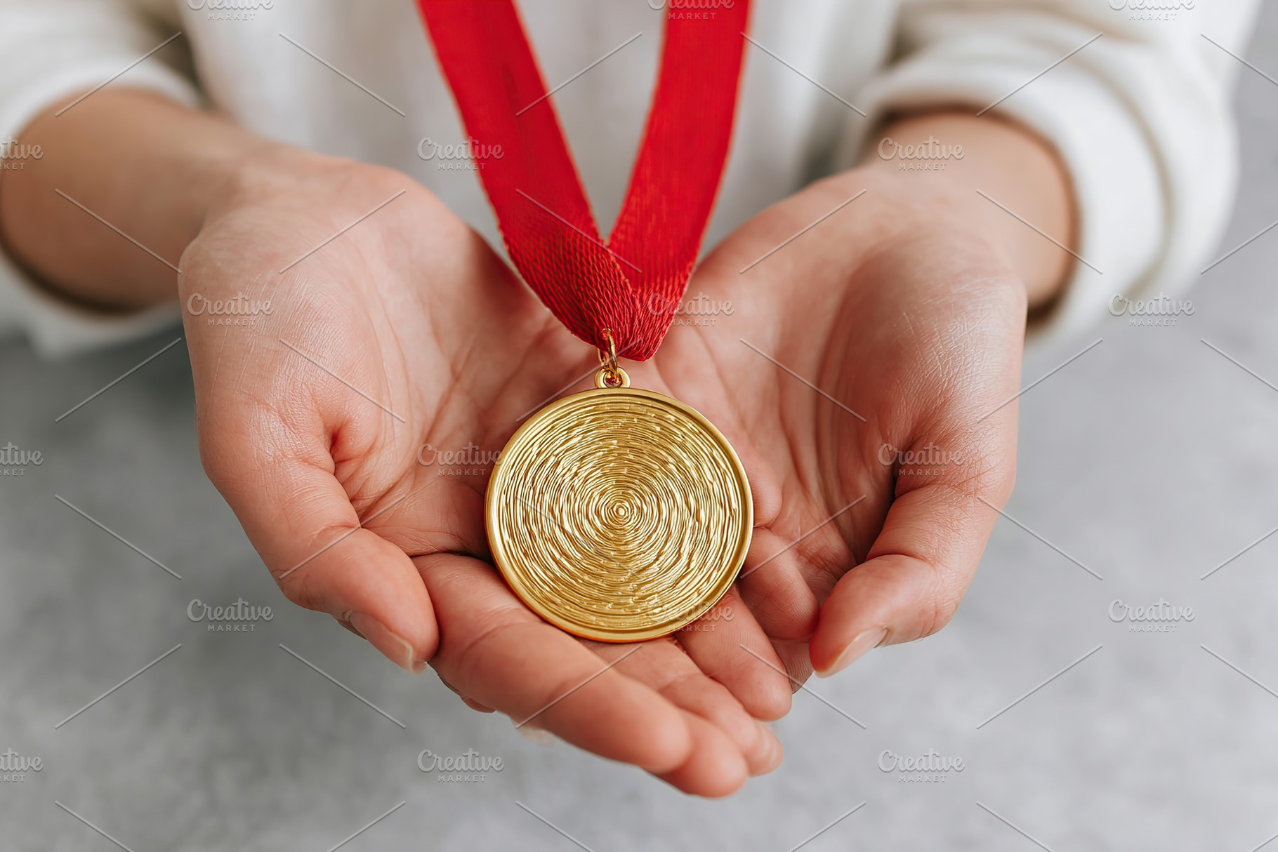 Holding a golden medal with red ribbon in hands after winning a competitive eve, a Sports & Recreation Photo by AlyaAnd