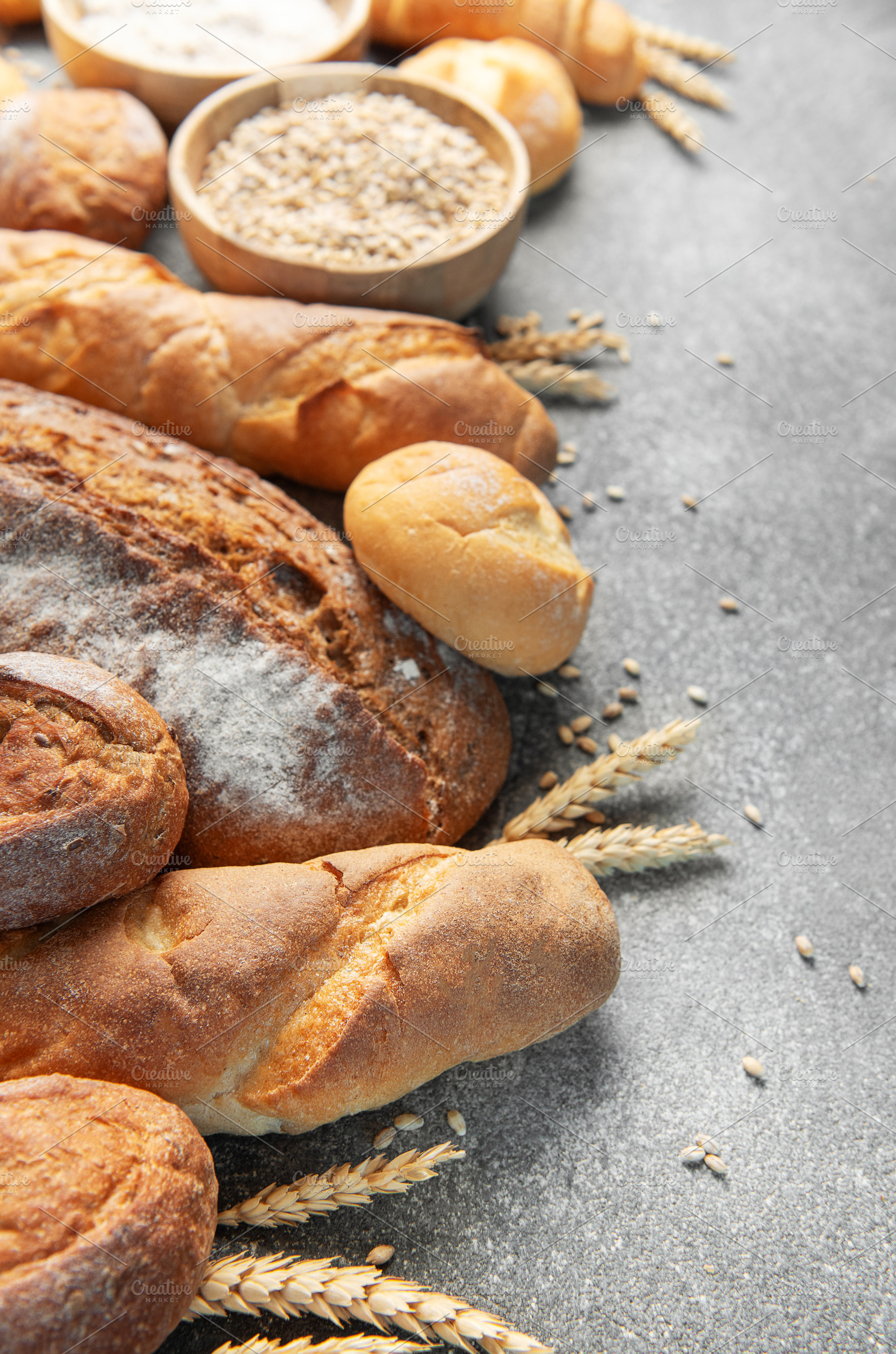 Assortment of fresh baked bread, grain, and flour, a Food & Drink Photo by Olena Rudo