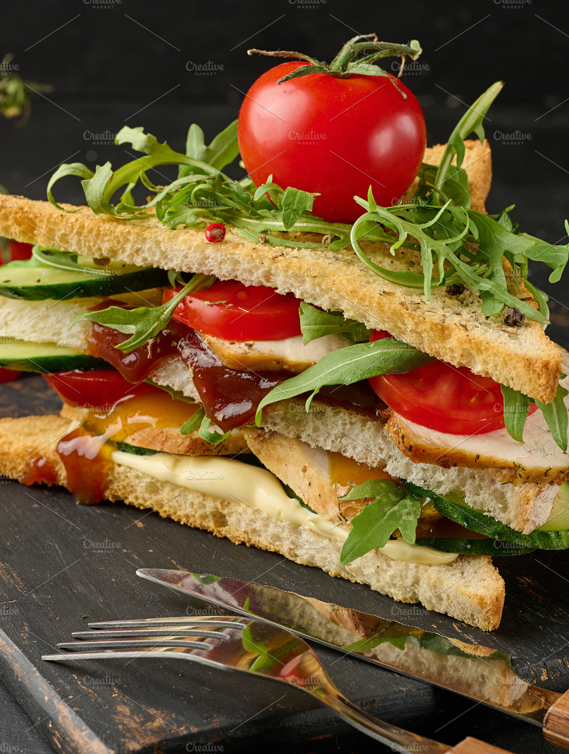 Grilled chicken sandwich with fresh tomatoes, cucumbers, arugula, a Food & Drink Photo by ndanko