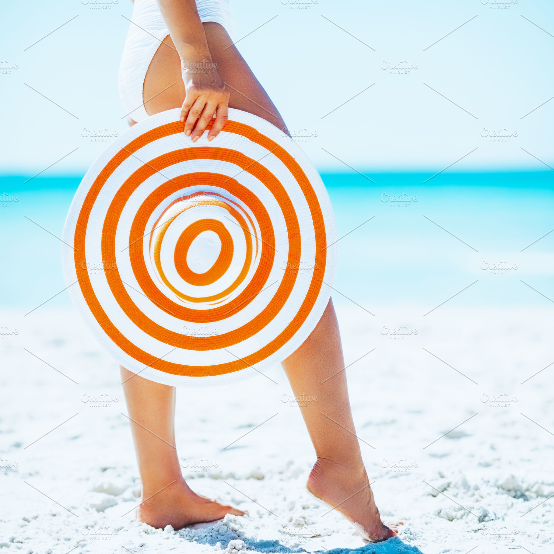 Closeup on young woman with hat on beach, a Person Photo by Alliance Images