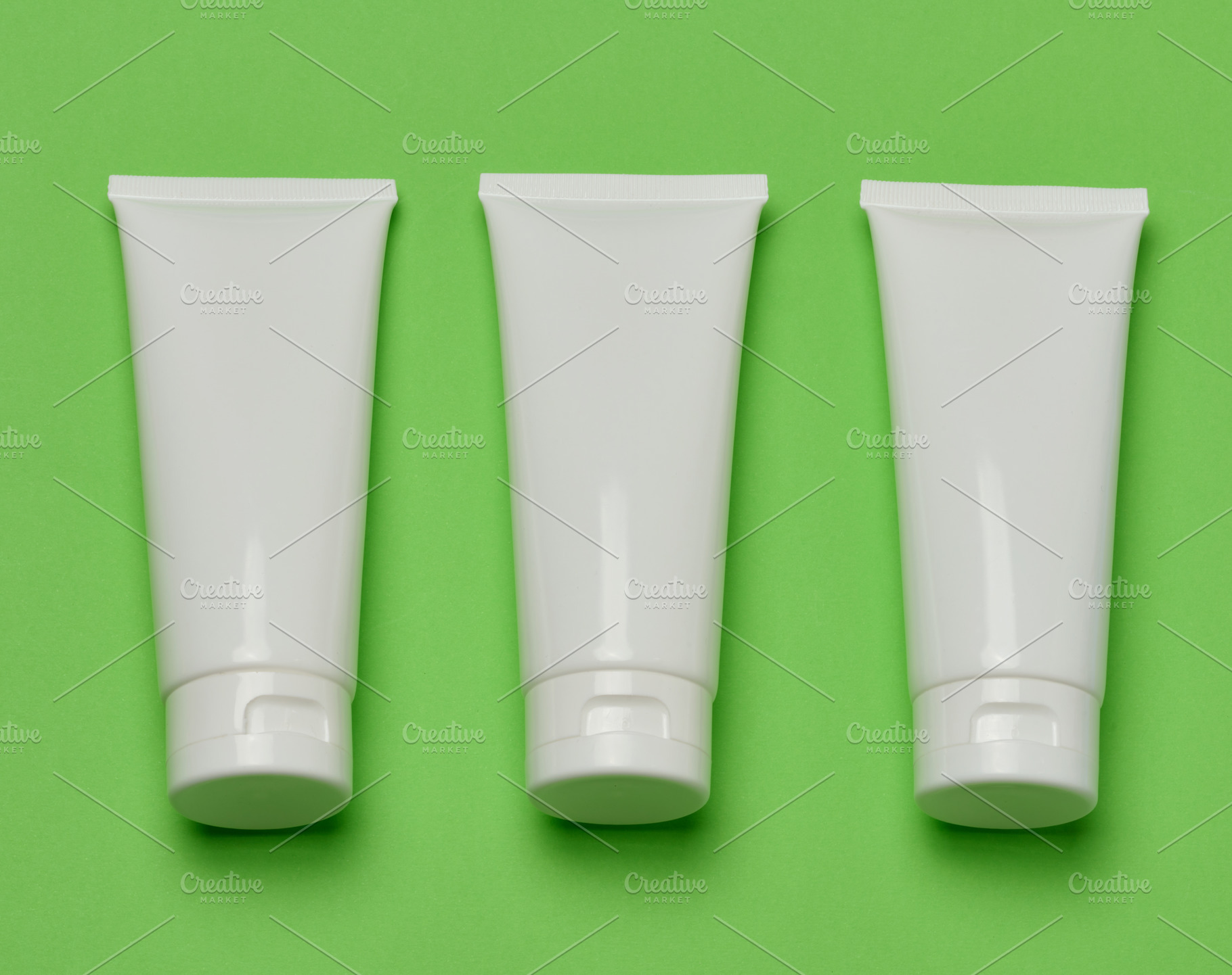 Three empty white plastic tubes for cosmetics or cream arranged, a Beauty & Fashion Photo by ndanko