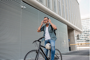 City commuter putting headphones on, a Person Photo by HalfPoint