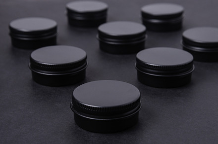 Set of tin metal boxes, cases. on black background, an Industrial Photo by MDBildes
