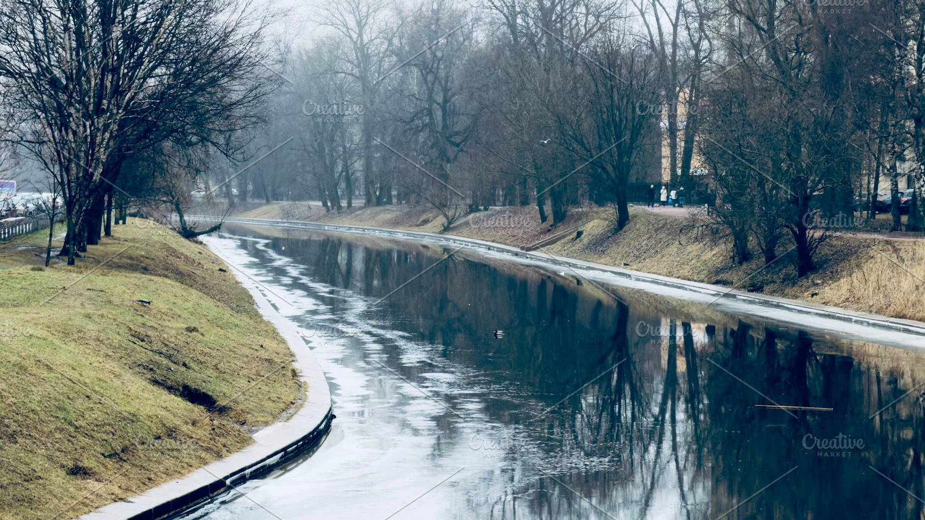 A tranquil river scene with calm water reflecting trees and a cloudy sky, surro, an Industrial Photo by Textures & Backgrounds