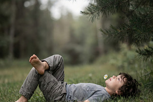 Peaceful Boy Lying on Grass, a Person Photo by Virgo Studio