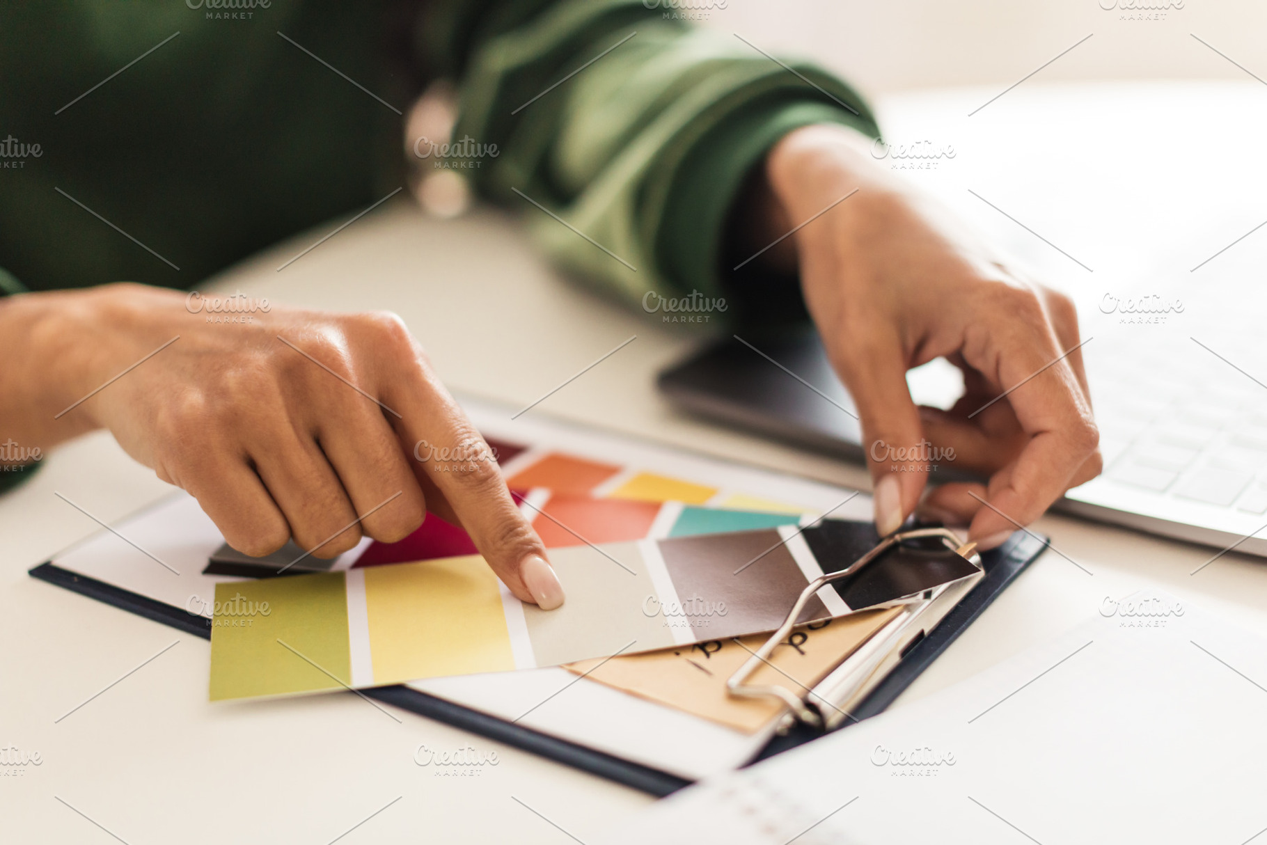 Closeup Of Female Hands Holding And Choosing Color Palettes Indoor, a Photo by Prostock-Studio