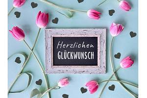Pink tulips and black hearts around, a Photo by tilialucida