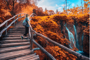 Woman with backpack walking on, a Person Photo by den-belitsky