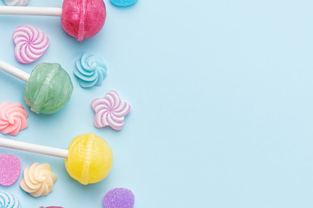 Sweet lollipops and candies on blue background, a Food & Drink Photo by Olena Rudo