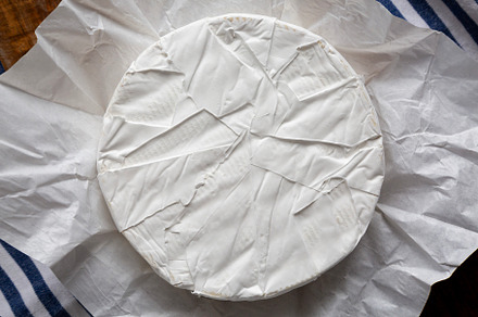 Homemade White Brie Cheese on a Wooden Board, top view., a Food & Drink Photo by LiudmylaChuhunova