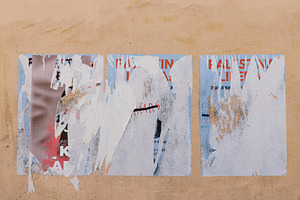 Scratched layers of posters and placards on a street wall, a Background Photo by Bepslabor