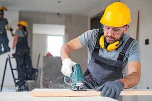 Construction Worker Cutting Wood wit, an Industrial Photo by Stock Shape