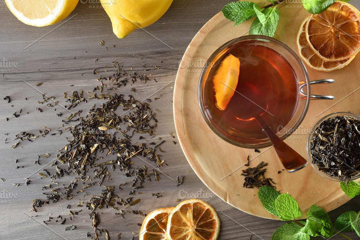 Black tea with lemon and mint on wooden table top, a Food & Drink Photo by Davizro's Market (Photo 2 of 2)