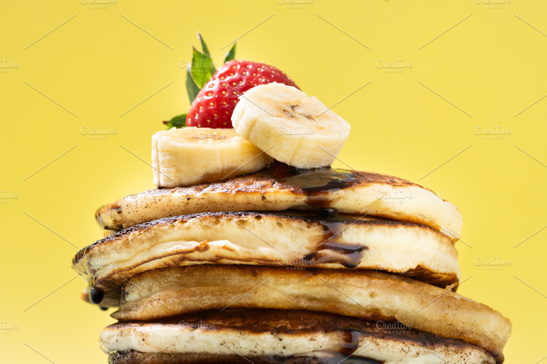 Pancakes with chocolate, strawberry and banana on yellow background, a Food & Drink Photo by etorres69
