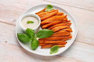 Sweet potato fries with dipping sauce and fresh basil, a Food & Drink Photo by Olena Rudo