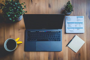 A sleek laptop on a wooden table, a Photo by Pavel_design