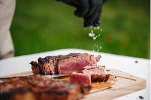 Chef salting juicy grilled steak on, a Food & Drink Photo by HalfPoint