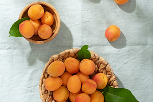 resh apricots on the light green linen tablecloth, a Food & Drink Photo by oxana.denezhkina