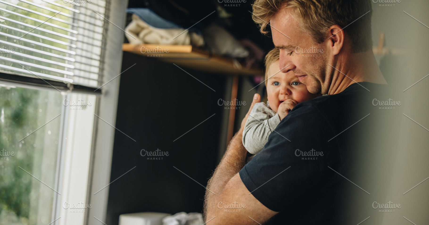 Father consoling his baby at home, a Person Photo by Jacob Lund
