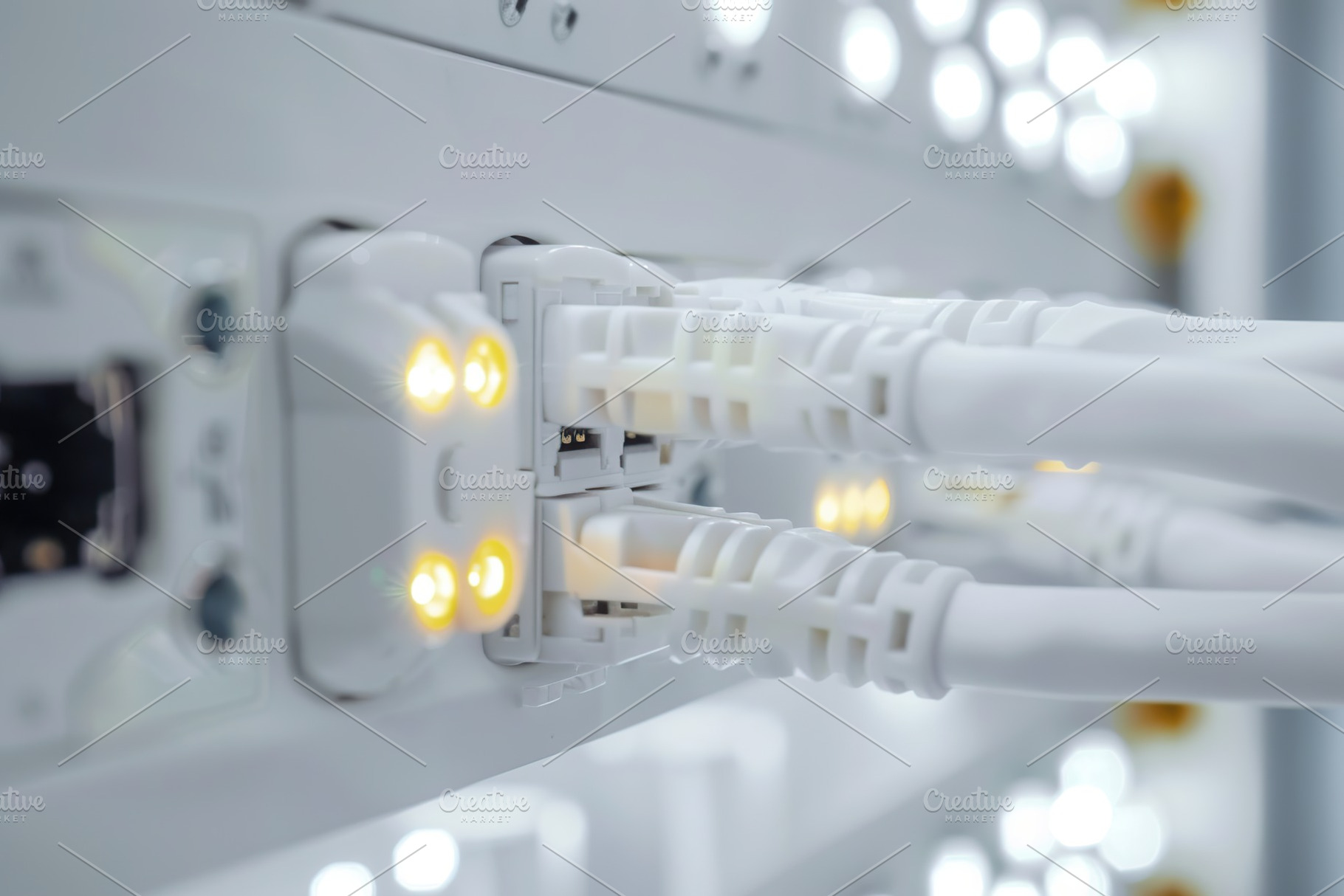 Fiber optic cables connected to optic ports. Network cables, a Photo by AlyaAnd