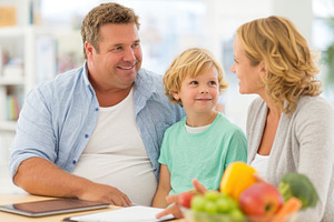 Happy family with overweight enjoying time together at home, a Person Photo by AlyaAnd