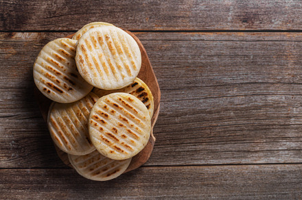 Traditional Venezuelan food arepa made from cornmeal, top view, a Food & Drink Photo by zakiroff