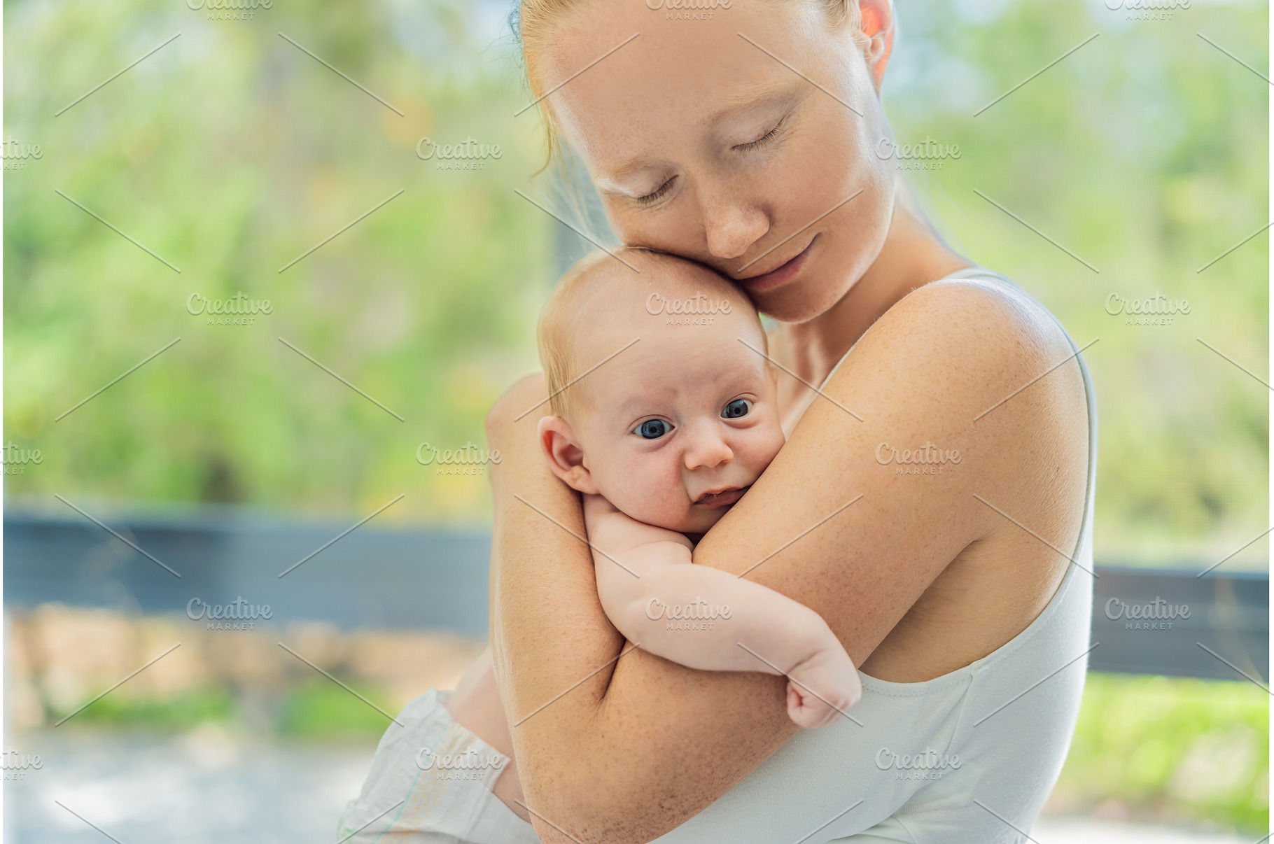 Mother gently hugging her baby at, an Architecture Photo by Elizaveta Galitskaya