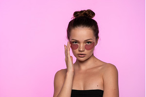 Young woman applying pink hydrating, a Beauty & Fashion Photo by volodymyrshtun13795