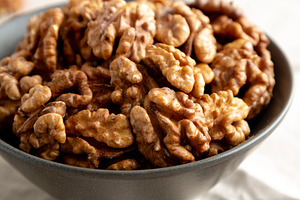 Raw Walnut Halfs in a Bowl, side view. Close-up., a Food & Drink Photo by LiudmylaChuhunova