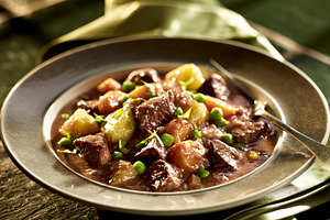 Beef stew simmering in a rustic bowl, offering a rich and warming comfort food, a Photo by Studio ANNA