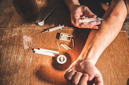 Man shooting heroin with needle featuring abuse, addicted, and addiction
