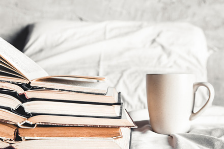 Stack of opened books with a coffee featuring background, design, and abstract
