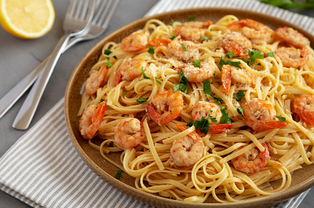 Baked Shrimp Scampi Linguine Pasta with Parsley on a Plate, side, a Food & Drink Photo by LiudmylaChuhunova
