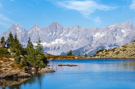 Calm autumn Alps mountain lake with clear transparent water and, a Nature Photo by YuriyB