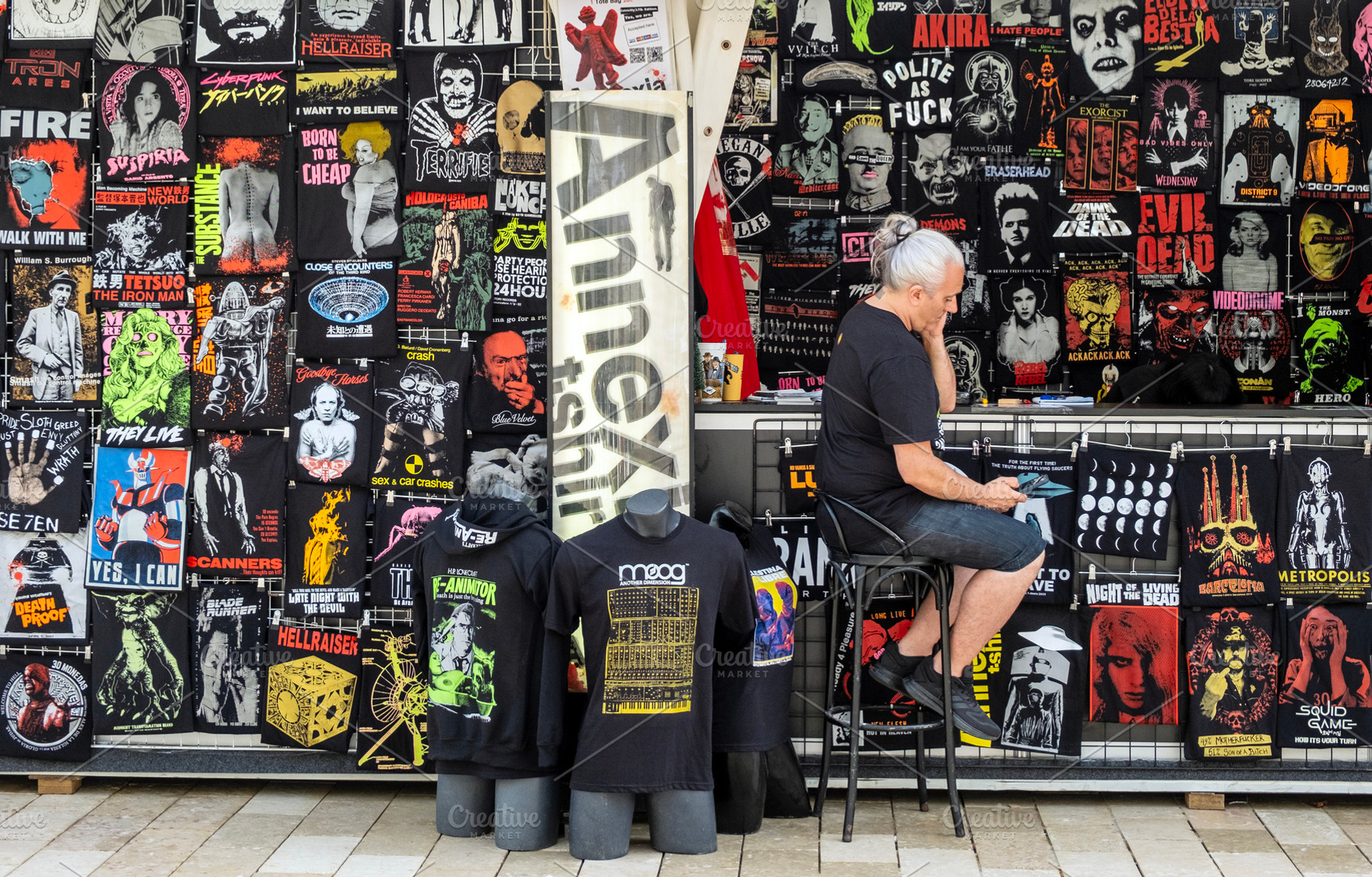 Tshirt market stand and seller, a Business Photo by BOOCYS