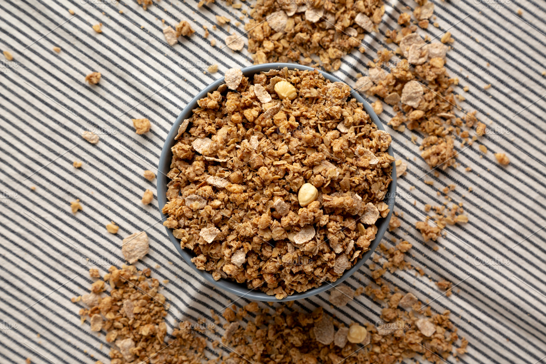 Healthy Homemade Toasted Muesli with Nuts in a Bowl, top view., a Food & Drink Photo by LiudmylaChuhunova