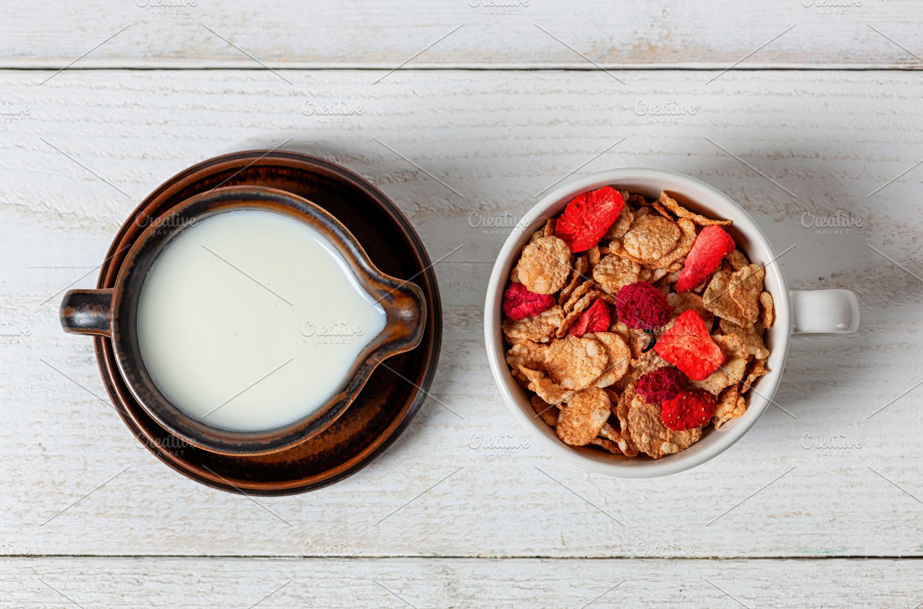 Healthy breakfast with milk and cereals with dried strawberries on white wooden, a Food & Drink Photo by Antonio Gravante Market