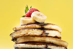 Pancakes with chocolate, strawberry and banana on yellow background, a Food & Drink Photo by etorres69