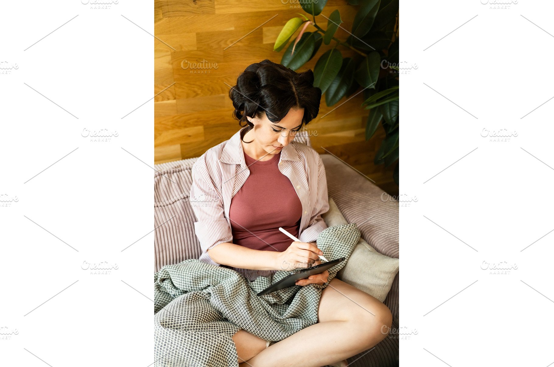 Woman with hair rollers journaling, a Person Photo by HalfPoint