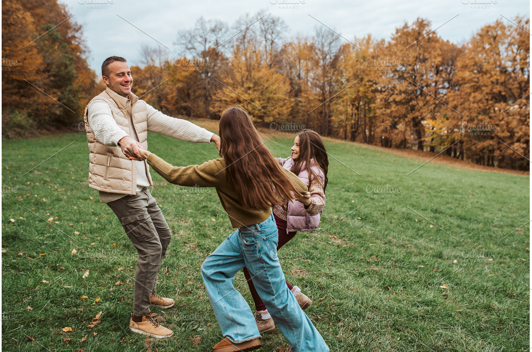 Father dancing with daughters, a Person Photo by HalfPoint