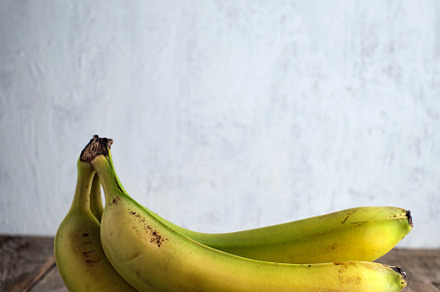 Fresh bananas on rustic wooden table, a Food & Drink Photo by alfernec
